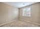 Cozy bedroom featuring plush carpeting and a window with shuttered blinds for privacy at 7709 Tiny Tortoise St, Las Vegas, NV 89149