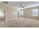 Spacious primary bedroom with neutral walls and plush carpeting at 7709 Tiny Tortoise St, Las Vegas, NV 89149