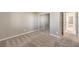 Carpeted bedroom with neutral walls, mirrored closet, and access to the hallway at 7709 Tiny Tortoise St, Las Vegas, NV 89149
