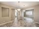 Dining room with tile floors and view to the staircase and kitchen at 7709 Tiny Tortoise St, Las Vegas, NV 89149