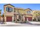 Inviting two-story home with desert landscaping, two-car garage and a tile roof on a sunny day at 7709 Tiny Tortoise St, Las Vegas, NV 89149