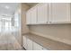 Hallway with storage cabinets and stone countertops with a window view on the side at 7709 Tiny Tortoise St, Las Vegas, NV 89149