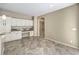 Kitchen area with granite countertops, built-in desk, and white cabinets at 7709 Tiny Tortoise St, Las Vegas, NV 89149