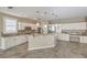 Spacious modern kitchen featuring a large island, built-in desk, and stainless steel appliances at 7709 Tiny Tortoise St, Las Vegas, NV 89149