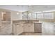 Kitchen island with sink and stainless-steel dishwasher in modern home at 7709 Tiny Tortoise St, Las Vegas, NV 89149