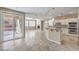 Open-concept kitchen and living area with an island, modern appliances, and sliding glass doors to the backyard at 7709 Tiny Tortoise St, Las Vegas, NV 89149