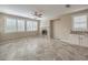 Spacious living room featuring tile flooring, a fireplace, and shuttered windows for ample natural light at 7709 Tiny Tortoise St, Las Vegas, NV 89149