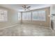 Bright living room with large windows, tile floors, and a cozy fireplace at 7709 Tiny Tortoise St, Las Vegas, NV 89149