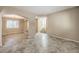Open-concept living room with tile floors and neutral walls at 7709 Tiny Tortoise St, Las Vegas, NV 89149