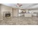 Open-concept living space with kitchen, fireplace and tile floors at 7709 Tiny Tortoise St, Las Vegas, NV 89149
