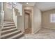 Entry hall staircase with tiled flooring and large windows at 7709 Tiny Tortoise St, Las Vegas, NV 89149