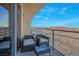 Balcony with comfortable seating offers panoramic views of the surrounding city and landscape at 8255 S Las Vegas Blvd # 1907, Las Vegas, NV 89123