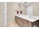 Bathroom vanity featuring modern fixtures, wood cabinets, and a neutral color palette at 8255 S Las Vegas Blvd # 1907, Las Vegas, NV 89123