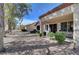 Landscaped backyard and covered patio offering a peaceful outdoor living space at 8657 Prairie Hill Dr, Las Vegas, NV 89134