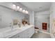 Bathroom featuring double vanity, bright lights, tile floors, and glass-door shower at 8657 Prairie Hill Dr, Las Vegas, NV 89134