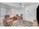 Comfortable bedroom featuring zebra rug, ceiling fan, and shuttered windows at 8657 Prairie Hill Dr, Las Vegas, NV 89134