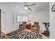 Relaxing bedroom with zebra rug, ceiling fan, and shuttered windows at 8657 Prairie Hill Dr, Las Vegas, NV 89134