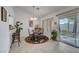 Charming dining area features a glass-top table and sliding glass doors to the patio at 8657 Prairie Hill Dr, Las Vegas, NV 89134