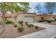 Exterior of single-Gathering home with a two car garage, a manicured lawn and desert landscaping at 8657 Prairie Hill Dr, Las Vegas, NV 89134