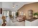 Open living room features neutral walls, vaulted ceilings, tile flooring, and ample natural light at 8657 Prairie Hill Dr, Las Vegas, NV 89134