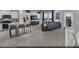 Open-concept showcasing the kitchen island seating and stylish living room furniture and decor at 883 Apatite Pl # Lot 57, Henderson, NV 89011