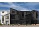 A modern exterior view of newly constructed townhomes showing contemporary architectural design and neutral color palettes at 9241 Soho Sky Ct, Las Vegas, NV 89148