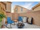 Backyard brick patio featuring a fire pit and outdoor seating, set against a brick wall at 1045 Spotted Saddle St, Henderson, NV 89015