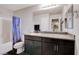 Bathroom with a blue Winnie the Pooh shower curtain, black cabinets, and granite countertops at 1045 Spotted Saddle St, Henderson, NV 89015