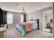 This bedroom features soft carpet, a decorative chandelier, and light neutral walls at 1045 Spotted Saddle St, Henderson, NV 89015