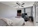 A tidy secondary bedroom featuring soft carpet, a ceiling fan, and ample natural light at 1045 Spotted Saddle St, Henderson, NV 89015