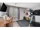 Bonus room with exercise equipment, piano and large windows letting in plenty of light at 1045 Spotted Saddle St, Henderson, NV 89015