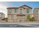 Charming two-story home with tan stucco, low-maintenance landscaping, and a cozy covered front porch at 1045 Spotted Saddle St, Henderson, NV 89015