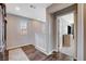 Bright hallway with wood floors leading to bedrooms, providing ample natural light at 1045 Spotted Saddle St, Henderson, NV 89015