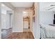 Hallway view of washer and dryer area, hardwood floors and access to a nearby bedroom at 1045 Spotted Saddle St, Henderson, NV 89015