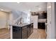 Contemporary kitchen with a central island, wood-look flooring, and abundant counter space for meal preparation at 1045 Spotted Saddle St, Henderson, NV 89015