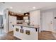 Bright kitchen with granite countertops, dark cabinets, a large island, and modern appliances for cooking convenience at 1045 Spotted Saddle St, Henderson, NV 89015