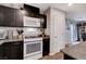 Well-lit kitchen with stainless steel appliances, dark wood cabinets and granite countertops at 1045 Spotted Saddle St, Henderson, NV 89015