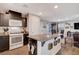 Modern kitchen featuring dark cabinetry, granite countertops, stainless steel appliances and a large island at 1045 Spotted Saddle St, Henderson, NV 89015