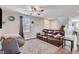 Inviting living room with a ceiling fan, plush leather couch, and ample space for relaxation and entertaining at 1045 Spotted Saddle St, Henderson, NV 89015