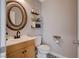 Small powder room with unique circular mirror and modern farmhouse decor at 1045 Spotted Saddle St, Henderson, NV 89015