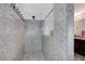 Modern shower with granite walls, tile flooring, and frameless glass door adding elegance at 1045 Spotted Saddle St, Henderson, NV 89015