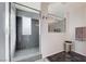 Modern shower with granite walls, tile flooring, and frameless glass door adding elegance at 1045 Spotted Saddle St, Henderson, NV 89015