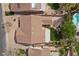 Aerial view of a well-maintained property featuring a pool, manicured landscaping, and a covered patio area at 1077 Las Palmas Entrada Ave, Henderson, NV 89012