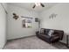 Bright bedroom featuring a leather futon, neutral walls, and plush gray carpeting at 1077 Las Palmas Entrada Ave, Henderson, NV 89012