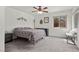 Well-lit bedroom featuring carpet, ceiling fan, decor, and backyard views through the window at 1077 Las Palmas Entrada Ave, Henderson, NV 89012