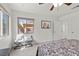 Neutral bedroom features neutral walls, carpet, ceiling fan, and bright windows with neighborhood views at 1077 Las Palmas Entrada Ave, Henderson, NV 89012