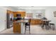 Open kitchen featuring a large island with bar seating, wood cabinets, and stainless steel appliances at 1077 Las Palmas Entrada Ave, Henderson, NV 89012