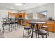 Bright kitchen features oak cabinets, granite countertops, and eat-in seating at a dark wood table at 1077 Las Palmas Entrada Ave, Henderson, NV 89012