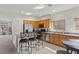 Bright kitchen features stainless steel appliances, granite counters, and an eat-in bar with wrought iron stools at 1077 Las Palmas Entrada Ave, Henderson, NV 89012