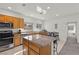 Kitchen with island, stainless steel appliances, granite countertops, and wood cabinets at 1077 Las Palmas Entrada Ave, Henderson, NV 89012